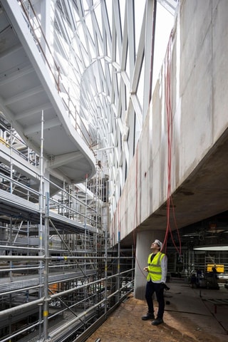 Construction worker looking up at atrium in Dublin Children's Hospital