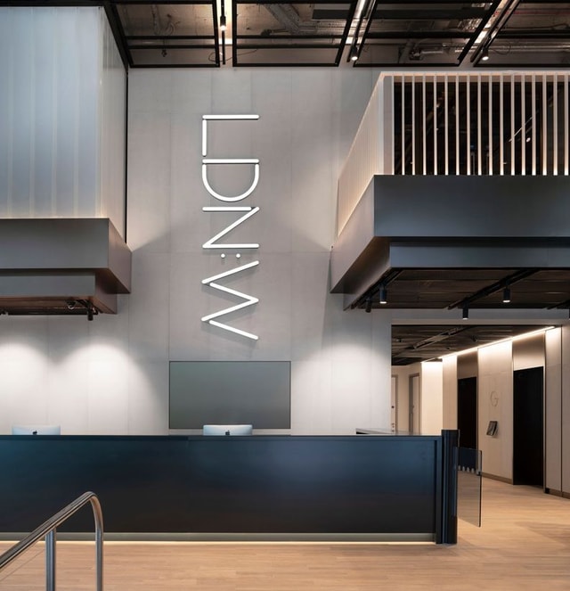 LDN-W Interior wall sig by the entrance dark wood light