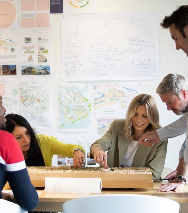 BDP designers reviewing a architectural model
